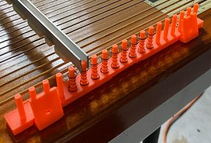 A chord bar comb for a 21-chord autoharp, printed on a 3d printer, using noextraterrestrialboi's design.  Click for a larger picture.