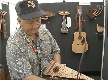 Archie Smith demonstrating a bowed psaltery at a festival in East Hampton, 2009. This is taken from a YouTube we list below.  Click for bigger photo.